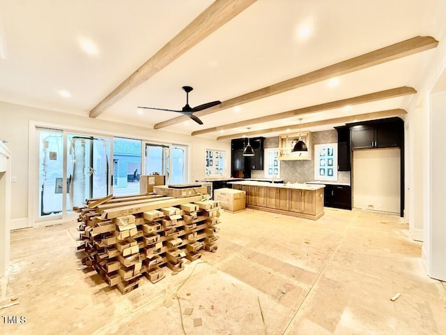 kitchen with a center island, ceiling fan, beam ceiling, decorative backsplash, and wall chimney range hood