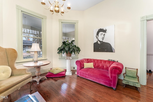 living area featuring hardwood / wood-style floors and a notable chandelier