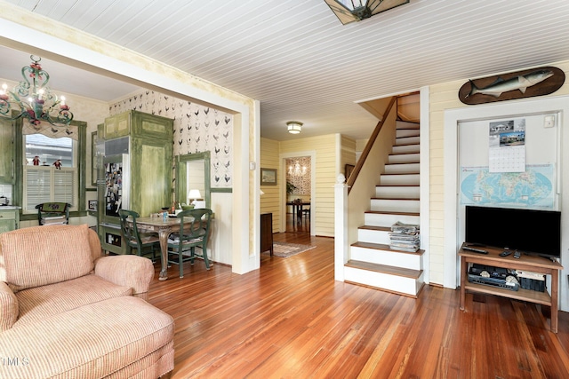 living room with an inviting chandelier and hardwood / wood-style flooring