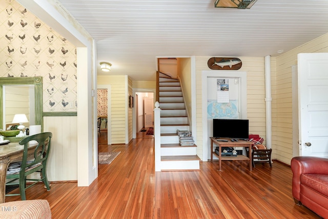 interior space with hardwood / wood-style floors and wood walls