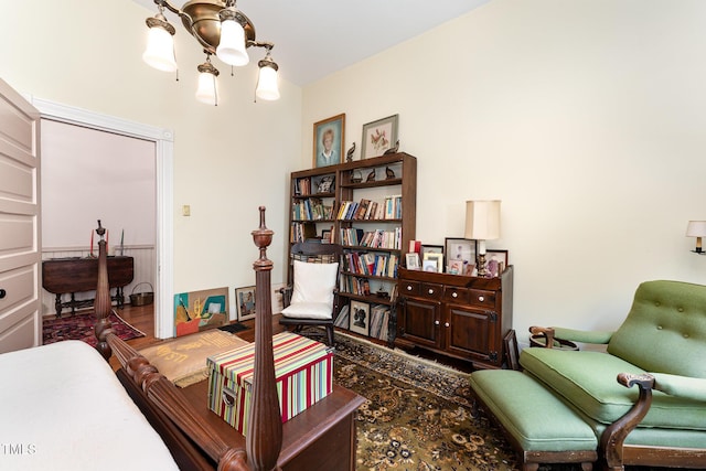 sitting room featuring wood-type flooring and a notable chandelier