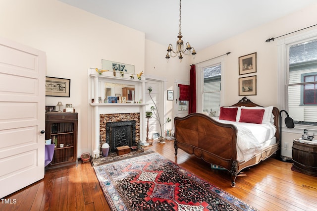 bedroom featuring wood-type flooring and a notable chandelier