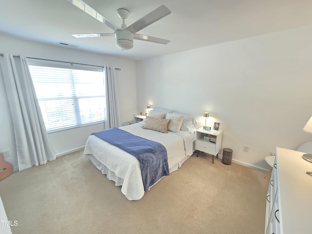 bedroom with ceiling fan and light carpet