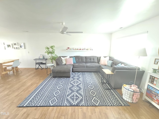 living room with ceiling fan and hardwood / wood-style flooring