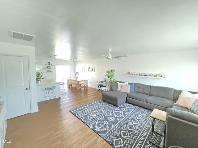 living room with ceiling fan and hardwood / wood-style floors