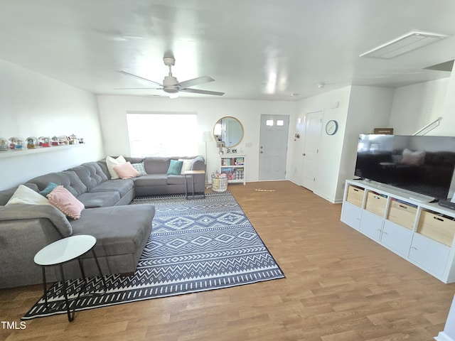 living room with ceiling fan and hardwood / wood-style floors