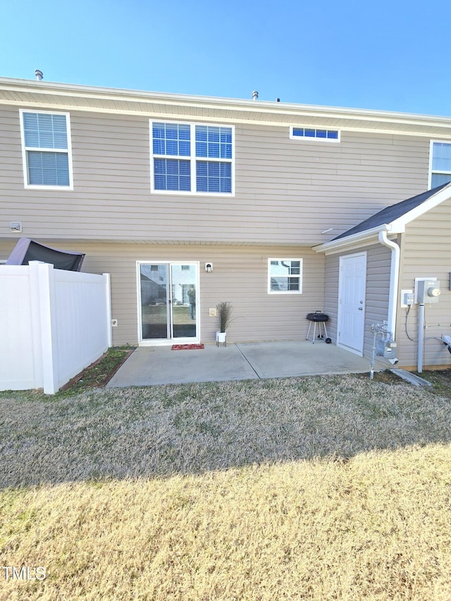 rear view of property with a patio area and a lawn