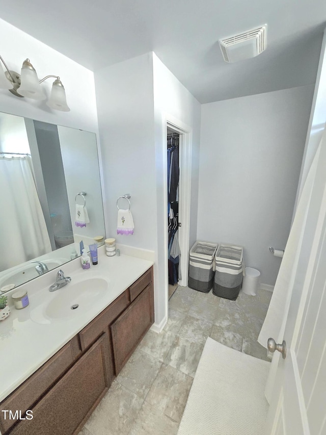 bathroom with toilet and vanity