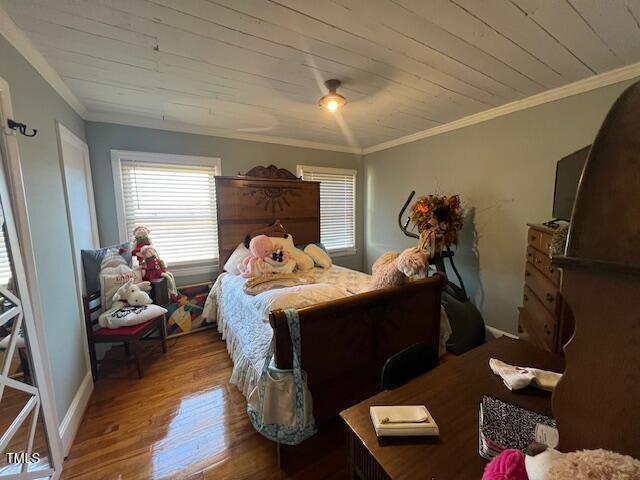 bedroom featuring ceiling fan, wooden ceiling, hardwood / wood-style floors, and crown molding