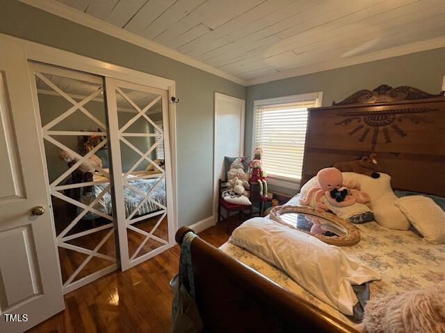 bedroom with wooden ceiling, ornamental molding, and dark hardwood / wood-style floors