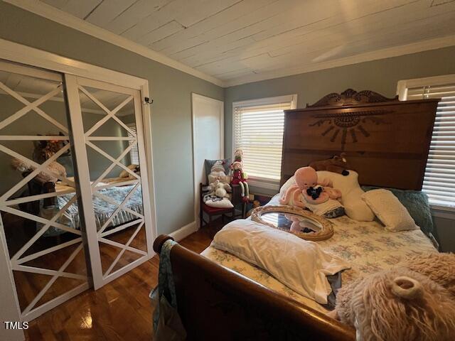 bedroom featuring crown molding, wood ceiling, dark hardwood / wood-style floors, and multiple windows