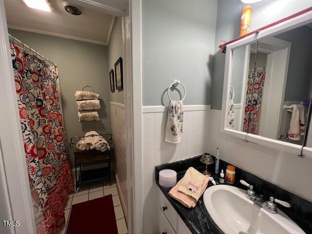 bathroom with tile walls, tile patterned floors, and vanity