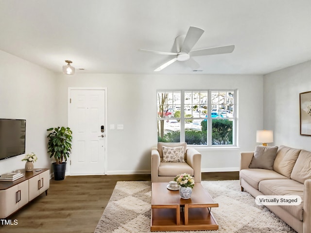 living room featuring ceiling fan and dark hardwood / wood-style flooring