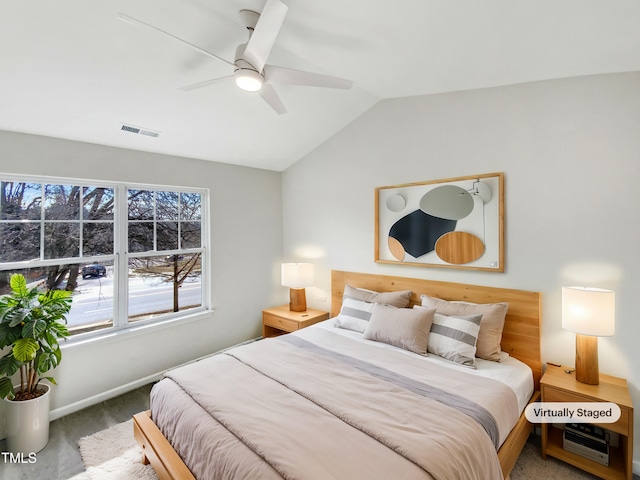 carpeted bedroom with vaulted ceiling and ceiling fan