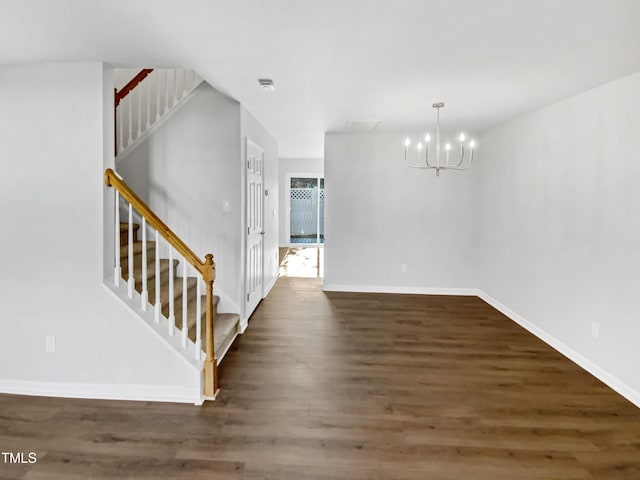 interior space with a notable chandelier and dark hardwood / wood-style floors