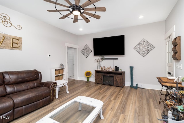 living room featuring hardwood / wood-style flooring and ceiling fan