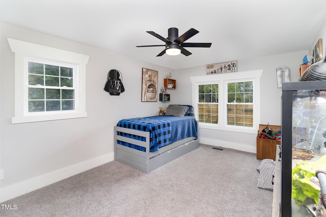 bedroom with ceiling fan and light carpet