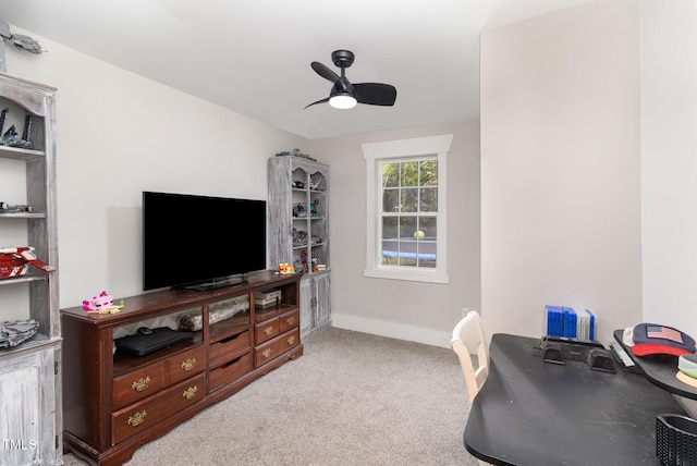 home office featuring light carpet and ceiling fan