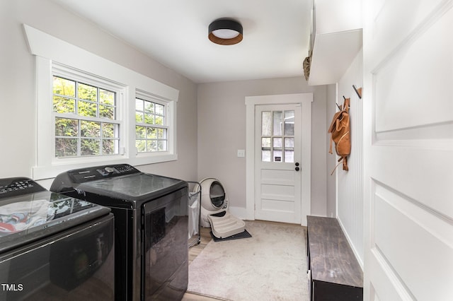 laundry room with washing machine and dryer and hardwood / wood-style floors