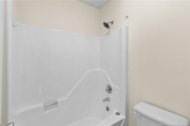 bathroom featuring shower / tub combination and toilet