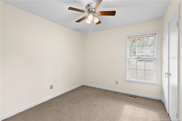 empty room with ceiling fan and carpet