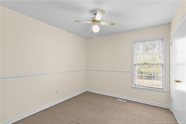 spare room with ceiling fan and carpet flooring