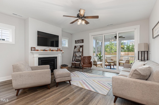 living room with hardwood / wood-style flooring and ceiling fan