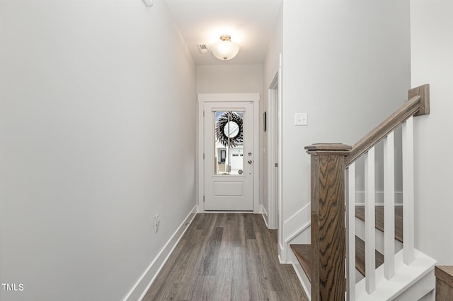 entryway with dark hardwood / wood-style flooring