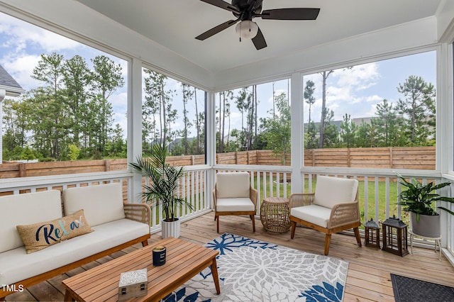 sunroom / solarium featuring ceiling fan