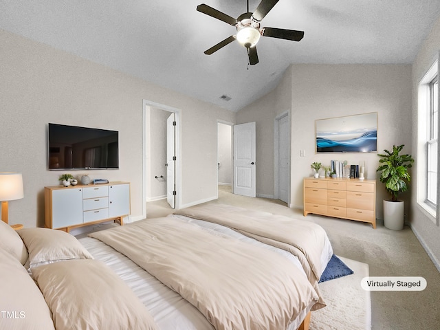 bedroom with ceiling fan, light carpet, and lofted ceiling