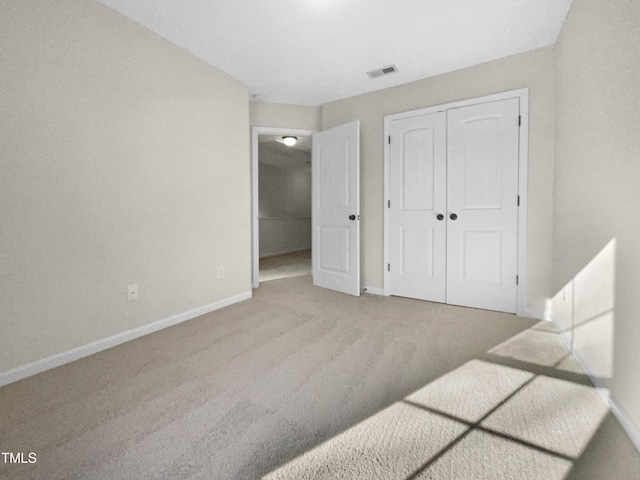 bedroom with light carpet and a closet