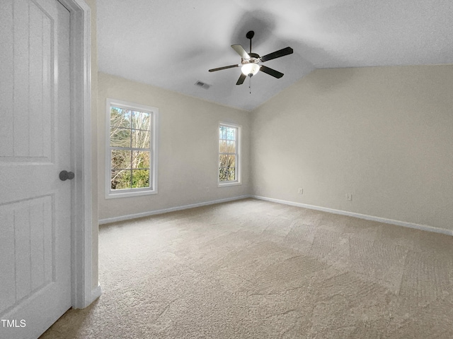 unfurnished room with ceiling fan, carpet, and vaulted ceiling