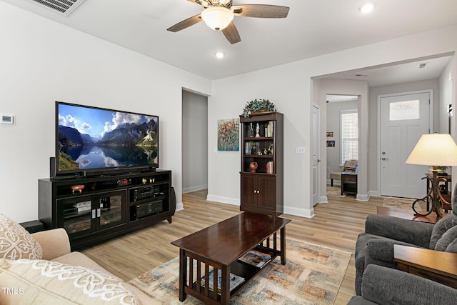 living room featuring ceiling fan and light wood-type flooring