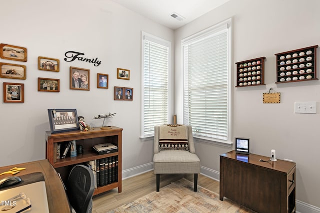 office area with a healthy amount of sunlight and light hardwood / wood-style floors