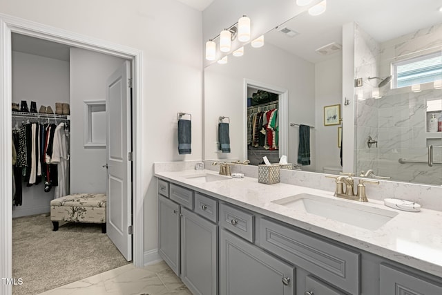 bathroom with vanity and a shower with shower door