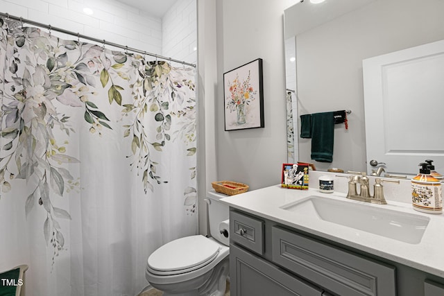 bathroom with walk in shower, vanity, and toilet