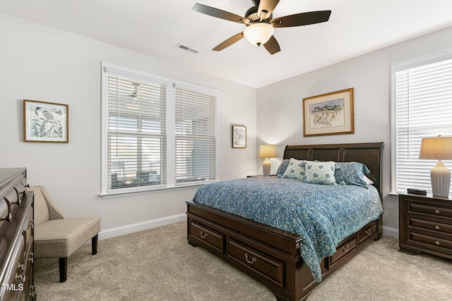 carpeted bedroom with ceiling fan and multiple windows