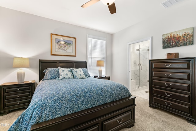 carpeted bedroom featuring ceiling fan and ensuite bath