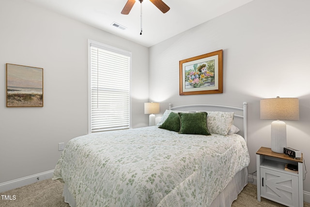 bedroom featuring light carpet and ceiling fan