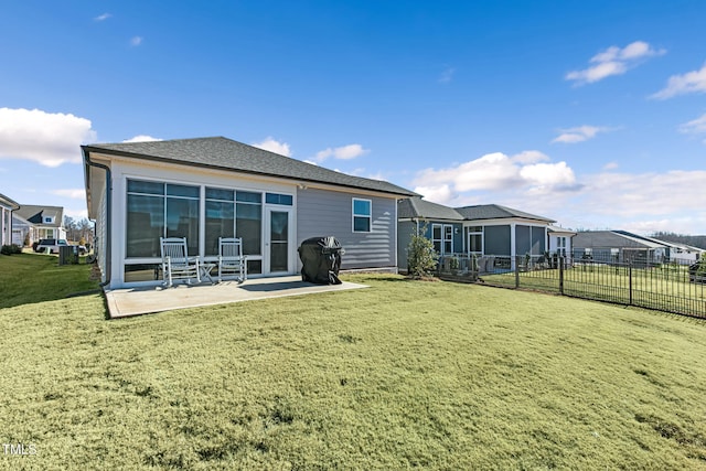 rear view of property featuring a yard and a patio