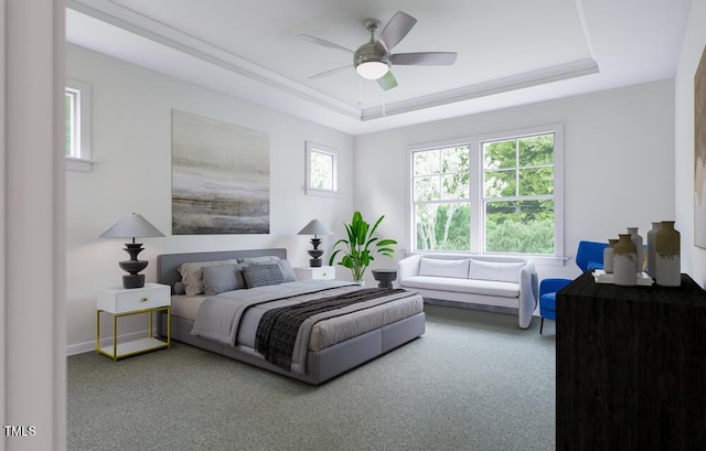 bedroom with ceiling fan, carpet flooring, and a tray ceiling