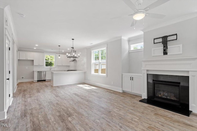 2905 Cammie St, Durham, NC 27705 - unfurnished living room with crown molding, light wood finished floors, a glass covered fireplace, a ceiling fan, and recessed lighting