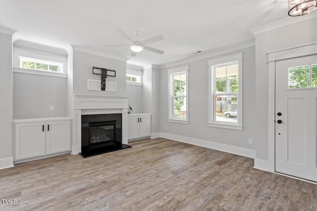 2905 Cammie St, Durham, NC 27705 - unfurnished living room featuring ornamental molding, light wood-style floors, ceiling fan, and a glass covered fireplace