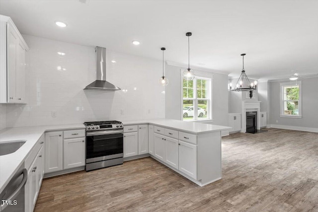 2905 Cammie St, Durham, NC 27705 - kitchen with wall chimney exhaust hood, stainless steel appliances, open floor plan, plenty of natural light, and recessed lighting