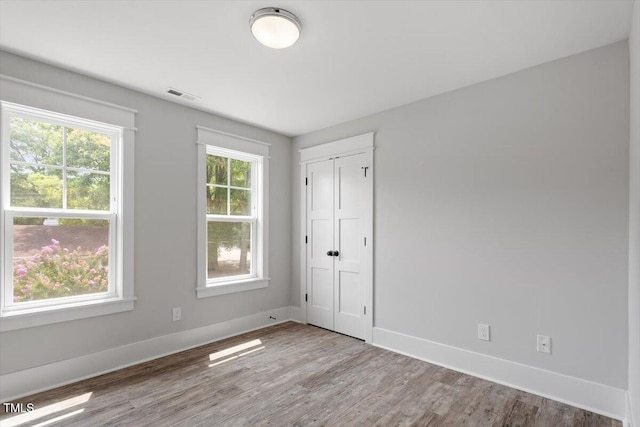 2905 Cammie St, Durham, NC 27705 - unfurnished bedroom with wood finished floors and a closet
