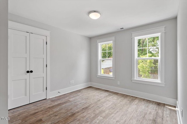 2905 Cammie St, Durham, NC 27705 - unfurnished bedroom featuring wood finished floors and a closet