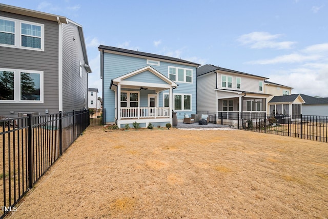 rear view of house featuring a porch and a yard