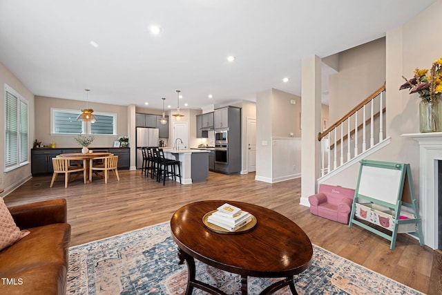 living room with sink and light wood-type flooring