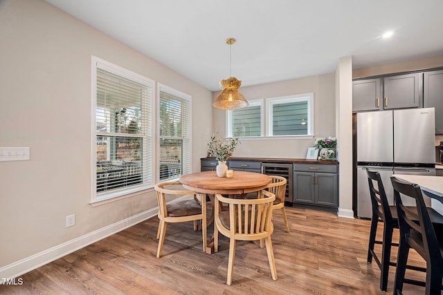 dining room with light wood-type flooring and wine cooler