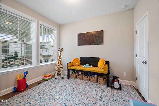 playroom with dark wood-type flooring